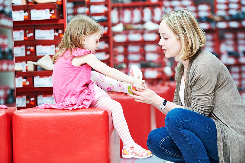family shopping choosing child footwear shoes